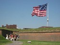 Flag flies over Fort McHenry, while historical reenactors kick off the celebration.