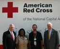 Rep. Hoyer stands with University of Maryland President Dan Mote and Red Cross workers outside a mobile data center vehicle.
