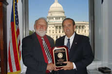 Congressman Costello receives 2010 Golden Triangle Award from National Farmers Union member, Norbert Brauer.