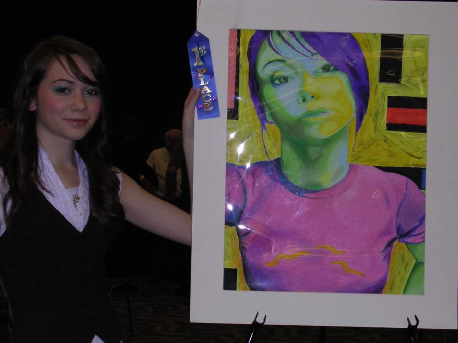 First place winner, Camille LaMontagne with her self portrait named "Geo" in oil pastel. 