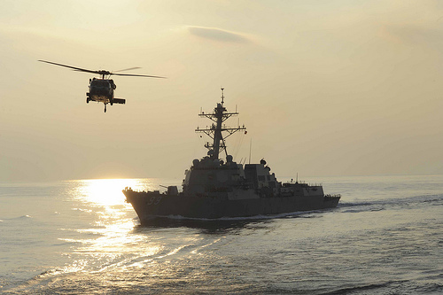 <p>A U.S. Navy MH-60S Knighthawk helicopter assigned to Helicopter Sea Combat Squadron (HSC) 8 flies past the guided missile destroyer USS Farragut (DDG 99) during a replenishment at sea in the Arabian Sea Dec. 4, 2012. Farragut was part of the John C. Stennis Carrier Strike Group and was under way in the U.S. 5th Fleet area of responsibility conducting maritime security operations, theater security cooperation efforts and support missions for Operation Enduring Freedom. (DoD photo by Mass Communication Specialist 2nd Class Kenneth Abbate, U.S. Navy/Released)</p>