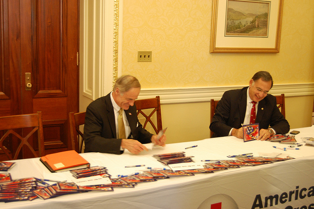Sen. Carper and Sen. Boozman sign letters together for the Holiday Mail for Heroes Program
