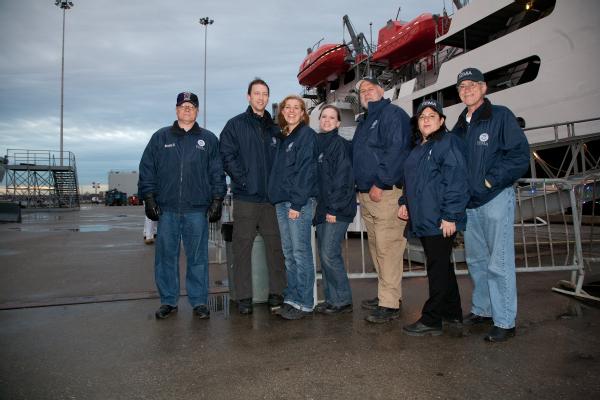 Melinda McDonough, team leader of Community Relations Team31, with her team in  front the training ship TS Kennedy. From left, Robert Staat, Allen Avery, Mishana Egan, Melinda McDonough, Don Jacobson, Annette Ambrosio,and Bryan English. 