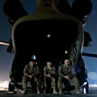 Photo: Spc. Kevin Buckhotz, flight engineer, Pvt. 1st Class Zachary Givens, Door Gunner and Spc. Jacob Owings, CH-47 Chinook helicopter crew chief with B Company, 6th Battalion, 101st CAB, Wings of Destiny pause for a moment before a slingload mission to take provisions to an outlying forward operating base at FOB Fenty, Afghanistan Dec. 8. (U.S. Army photo by Sgt. Duncan Brennan, 101st CAB public affairs)
