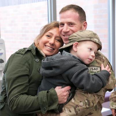 Photo: Valerie Kagan and her son Sean, hold on tightly to Sgt 1st Class Jeremy Kagan, 2nd Brigade, 2nd Infantry Division (Official Page), after a welcome home ceremony at Joint Base Lewis-McChord Dec. 16. Read more about the ceremony here: http://www.dvidshub.net/news/99493/lancer-brigade-soldiers-make-home-holidays