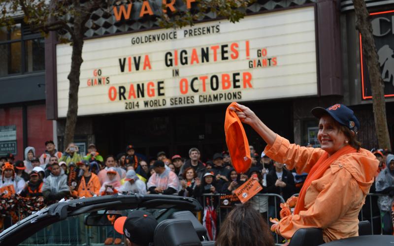Congresswoman Pelosi waves to crowd during the San Francisco Giants’ victory parade for their triumphant win as 2014 World Series Champions.