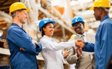 warehouse manager shaking hands with warehouse worker