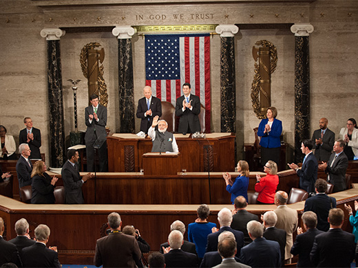 India’s Prime Minister Narendra Modi waving from his podium to the members of Congress.