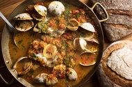 This fish stew with classic Mediterranean flavors is served with garlic toast.