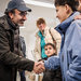 Hamdi Ulukaya, left, founder of Chobani, visiting a refugee center in Hamburg, Germany, in May.