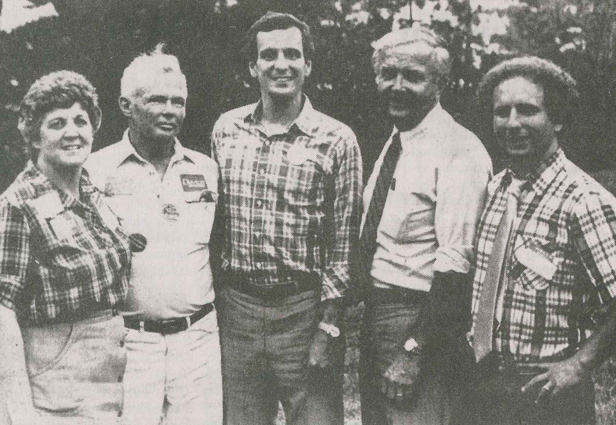 Governor Mark Dayton stands for a picture with a group of people and U.S. Senator Paul Wellstone in 1982.