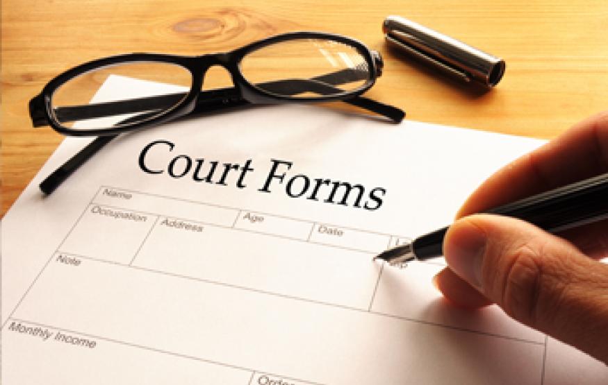 image of someone filling in a court form