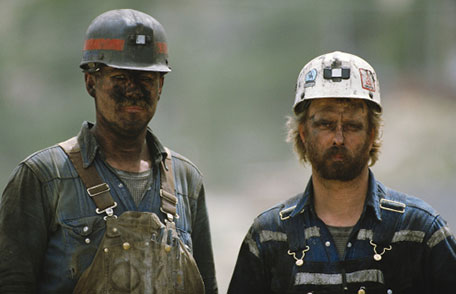 Photo of two coal miners covered in coal dust 