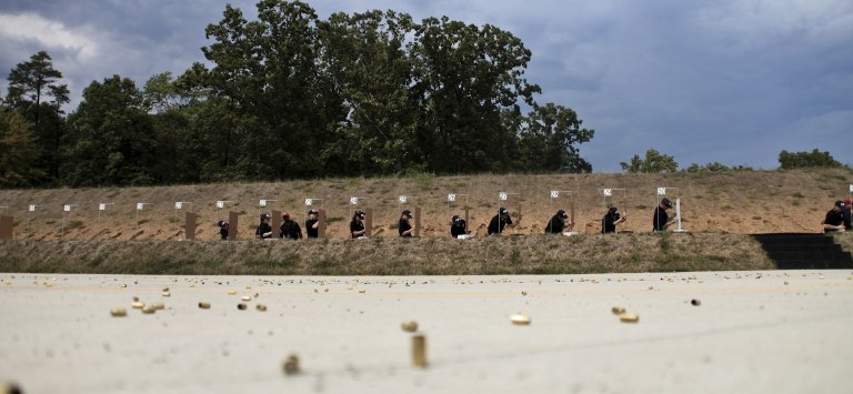 New agent trainees score their targets in 2010, leaving behind their spent shell casings (in the foreground).