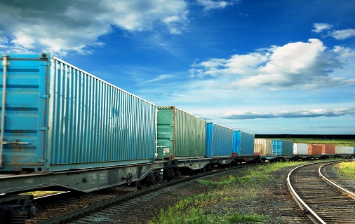 Train with shipping containers on train tracks