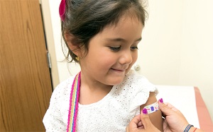 Image of young girl receiving influenza vaccination.