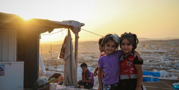 Smiling girls hugging at a refugee camp.©EC/ECHO/IOM Iraq