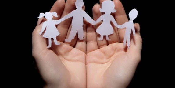 family cut out of paper in hands