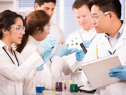 multi-ethnic group of scientists in lab