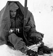 Soldier sitting in the snow under a blanket in the Chosin Reservoir