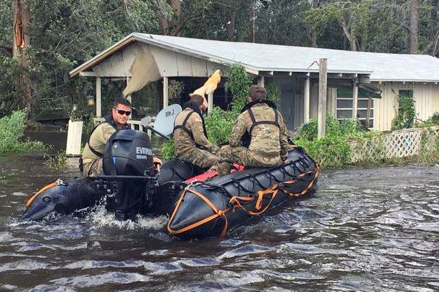 Soldiers use a boat to conduct search and rescue missions.