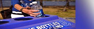 Photo of a woman recycling a plastic bottle