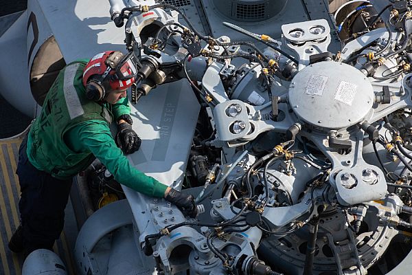 A Sailor conducts maintenance on an MH-60R Sea Hawk, assigned to Helicopter Maritime Strike Squadron (HSM) 71, on the flight deck aboard the aircraft carrier USS John C. Stennis (CVN 74). The John C. Stennis Carrier Strike Group is deployed to the U.S. 5th Fleet area of operations in support of naval operations to ensure maritime stability and security in the Central Region, connecting the Mediterranean and the Pacific through the western Indian Ocean and three strategic choke points.  U.S. Navy photo by Mass Communication Specialist Seaman Apprentice Jarrod A. Schad (Released)  181222-N-HX510-0138