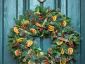 green christmas wreath hanging on green door