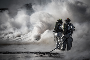 Firefighters from the 366th Civil Engineer Squadron extinguish a fire during a fire training exercise March 4, 2013, at Mountain Home Air Force Base, Idaho. Two teams worked in unison to push the fire back without it reigniting behind them. The training exercise was one component of a base-wide operational readiness exercise. (U.S. Air Force photo/Tech. Sgt. Samuel Morse)
