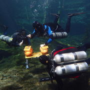 divers deploy acoustic devices in centoes in the Yucatan Peninsula, Mexico