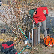 USGS hydrologist measuring groundwater level in a well