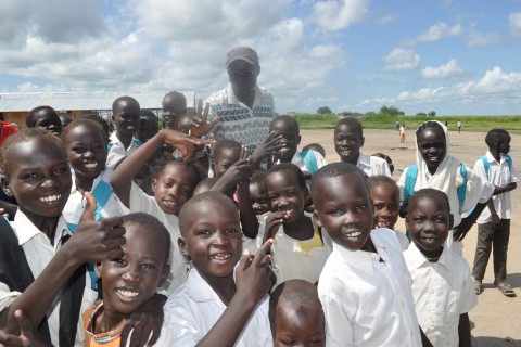 Children at Payuer Primary School in Renk, South Sudan, with the school's founder and head teacher, Ali Kenyi