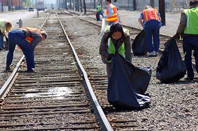 Responders cleaning debris at a railroad track.