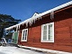 Photo of a sideview of a red house with icicles hanging off the gutters. Opens drop down listing of Energy Assistance Programs information.