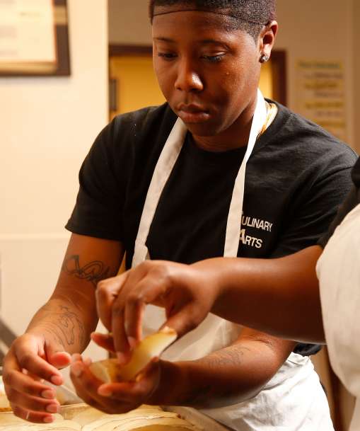 Culinary Arts students cut potatoes
