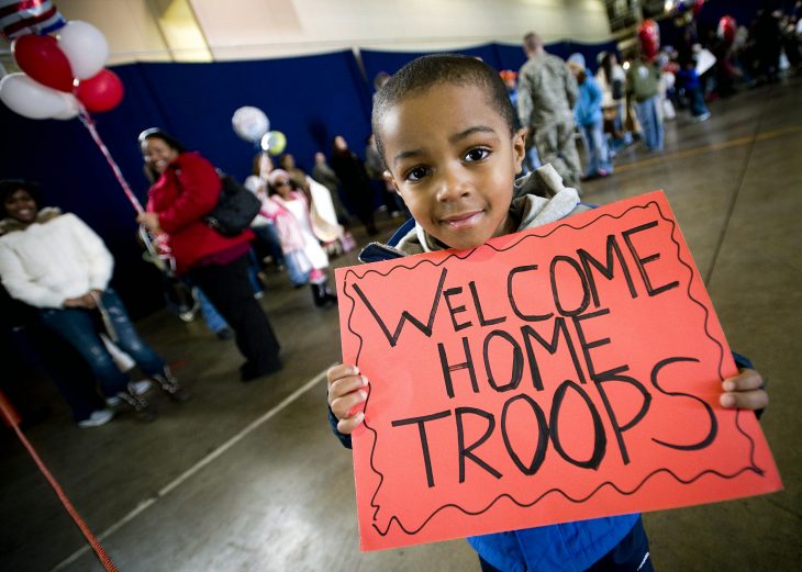 Child welcomes home US Military troops at the airport
