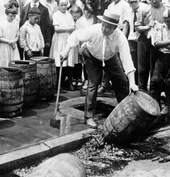 Police destroyed beer kegs when the Eighteenth Amendment took effect in 1920, banning the sale of alcoholic beverages.