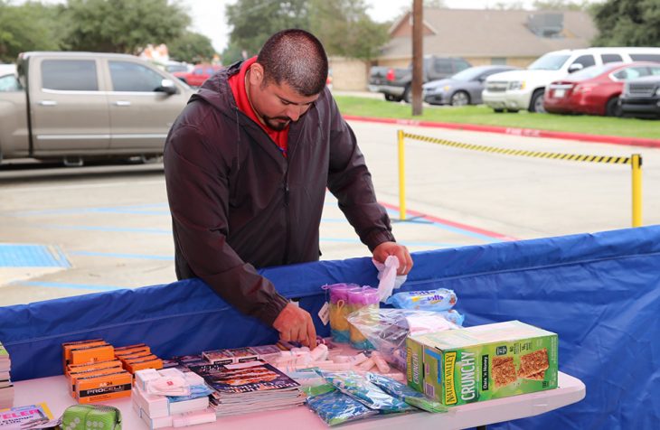 Laredo Vet Center counselor, Tobert Garcia carefully arranges some personal hygiene items donated during the Boots & Badges care package drive held October 26, 2018, at Vet Center in Laredo, Texas. (U.S. Department of Veterans Affairs photo by Luis H. Loza Gutierrez)