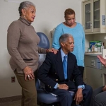 Older man with his 2 daughters at a doctor's appointment