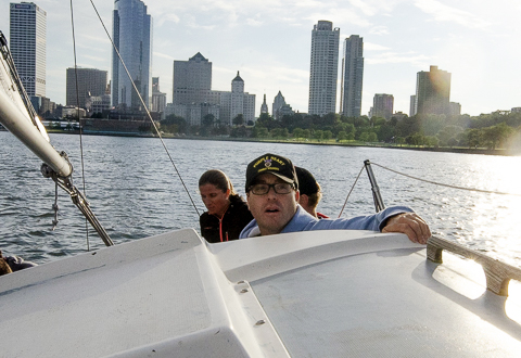 Mark Duran, an Army Veteran wounded in Afghanistan, guides the boat through the harbor.