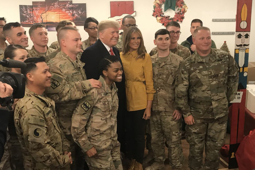 President Donald J. Trump and First Lady Melania Trump pose with troops.