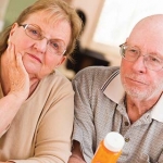 Older couple listening about the benefits, risks, and safety protections of clinical trials