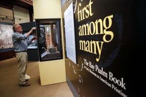 Chris O'Connor, lead exhibition production specialist, prepares the "First Among Many: The Bay Psalm Book and Early Moments in American Printing" exhibition for the June 4 opening in the South Gallery. Photo by Shawn Miller.