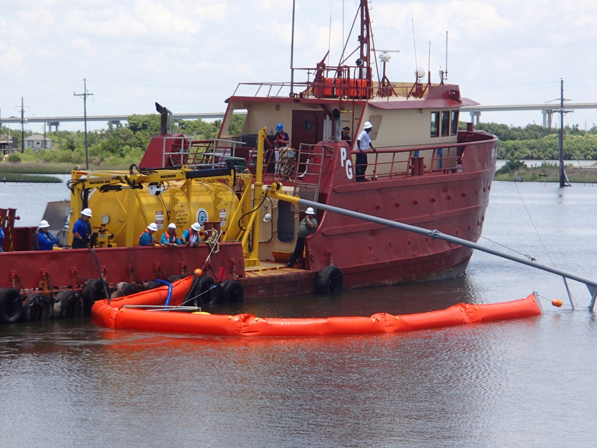 An oil spill removal organization vessel deploys a  boom and weir skimming system in the Gulf of Mexico during an exercise.