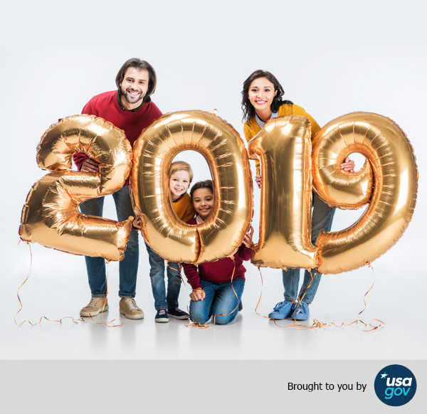 Smiling parents with siblings holding sign 2019 made of golden balloons for new year, Brought to you by USAGov.