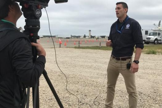FEMA Region III Operational Planner Matt Wiedemer speaks with a reporter on preparation activities at Fort Bragg, North Carolina in anticipation of Hurricane Matthew.