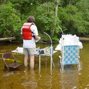 Scientist at research table set up in the river