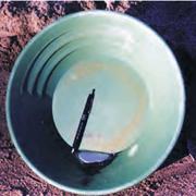 Green pan used for gold mining with a small amount of mercury in it