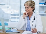 Photo of a doctor looking at a computer