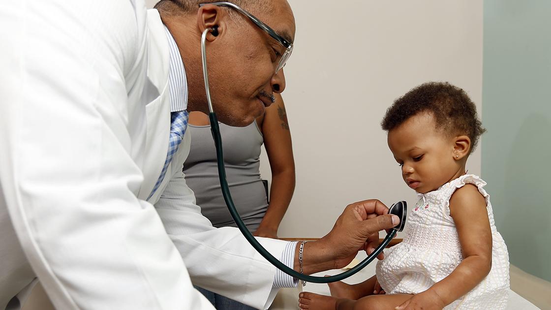 African american doctor with child patient